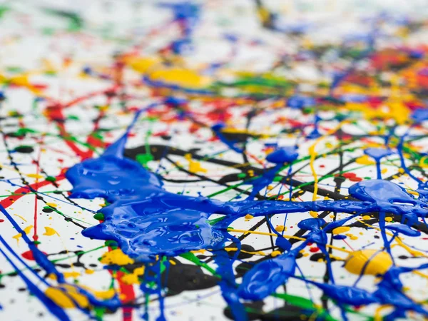 Abstract expressionism art creative background. art of splashes and drips . red black green yellow blue paint on white background.