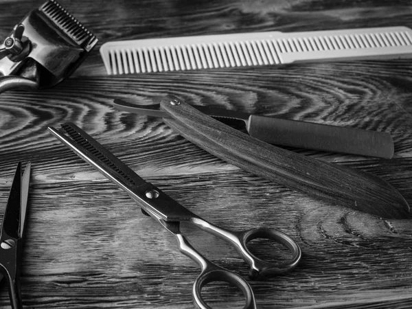 barber shops tools on wooden desk. bw