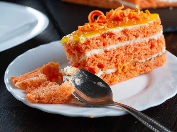 One bitten piece of carrot cake lies on a white plate. — Stock Photo, Image