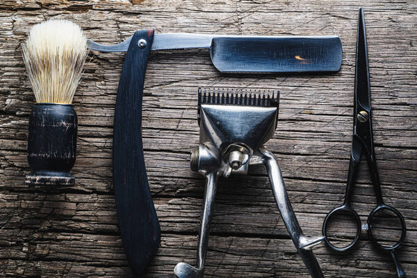 Vintage barber shop tools on wooden background. Masculine, flat lay, top view. Horizontal orientation