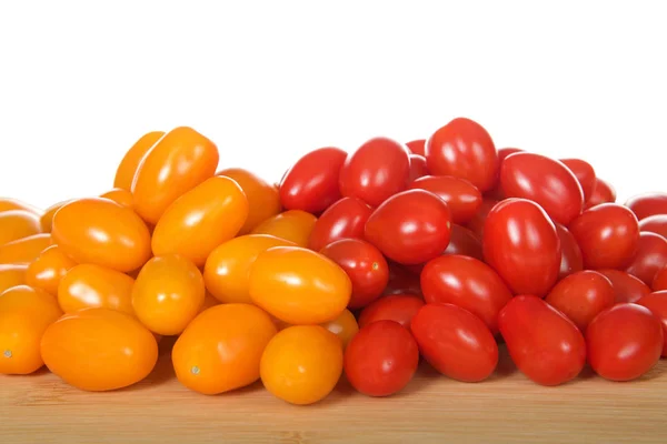 Zima, an orange grape tomatoes next to Angel Sweet grape Tomatoes. Both great for salads or snacking.