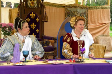 Fairfield, CA - April 6, 2019: Unidentified participants at the Tartan Festival, a Scottish living history festival hosted by the East Bay Scots at Ardenwood Farms. Mary, Queen of scots eating