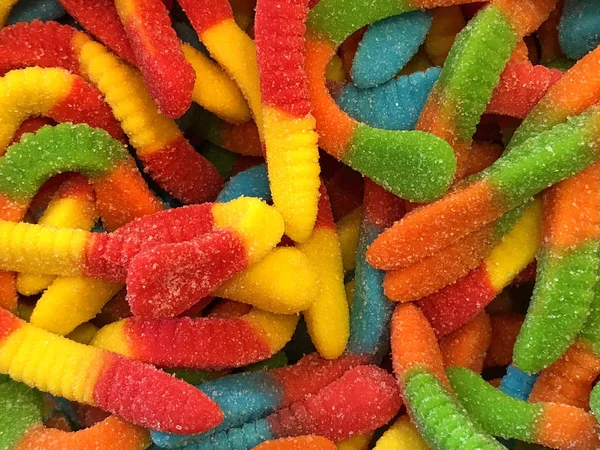 Background Candy Coated Gummy Worm Candies Red Yellow Green Blue — Stock Photo, Image