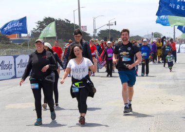 San Francisco, Ca - 20 Mayıs 2018: 107. geleneksel Bay to Breakers yarışının kimliği belirsiz katılımcıları bitiş çizgisine yaklaşıyor. Bay to Breakers kostüm giyen birçok katılımcısıyla ünlüdür..