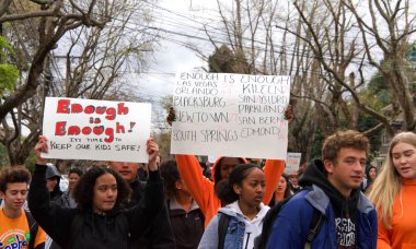 Alameda, CA - March 14, 2018: With calls to End gun violence, no more silence! hundreds of students from Alameda High School participate in a student walkout to protest gun violence.  clipart