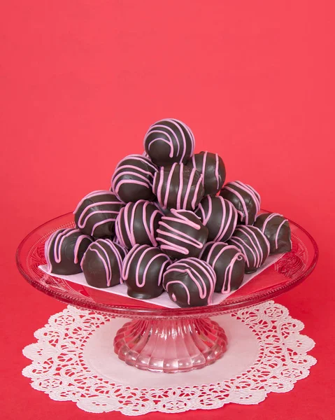 Chocolate cake balls stripped  pink candy melts stacked on plate — Stock Photo, Image