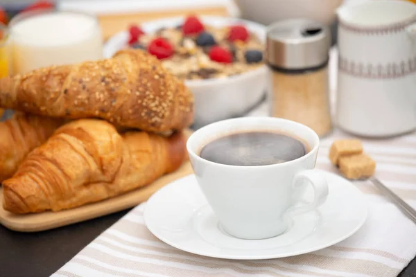 Breakfast Served in the morning with Hot black coffee and croissants Natural corn flake breakfast cereal in cups and fruit on the breakfast table every day