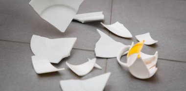 Kırık tabak ya da kırık su bardağı ve mutfak odasında yerde tabaklar. Mutfaktaki kaza kavramı, evin içindeki beden ve çocuklar için tehlikelidir..