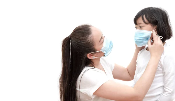 The image face of a young Asian woman and family wearing mask to prevent germs, toxic fumes, and dust. Prevention of bacterial infection in the air in a white background