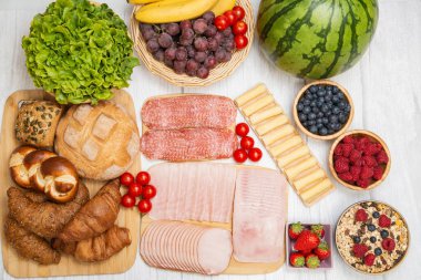 Sabah kahvaltı masada kruvasan ekmeği, kruvasan gevreği, pastırma, jambon, peynir, marul, fasulye, mısır gevreği, sağlıklı kahvaltı için meyve ve fotokopi alanı ile servis edilir.