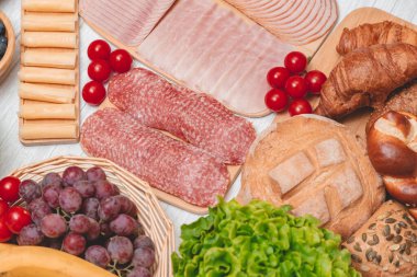 Sabah kahvaltı masada kruvasan ekmeği, kruvasan gevreği, pastırma, jambon, peynir, marul, fasulye, mısır gevreği, sağlıklı kahvaltı için meyve ve fotokopi alanı ile servis edilir.