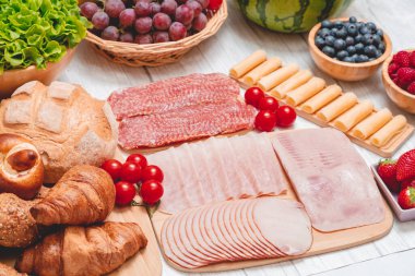 Sabah kahvaltı masada kruvasan ekmeği, kruvasan gevreği, pastırma, jambon, peynir, marul, fasulye, mısır gevreği, sağlıklı kahvaltı için meyve ve fotokopi alanı ile servis edilir.