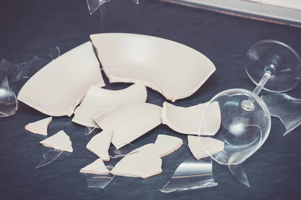 Broken Plate or broken water glass on the on the floor in the kitchen The concept of accidents in the kitchen is dangerous for the body and young children inside the house.