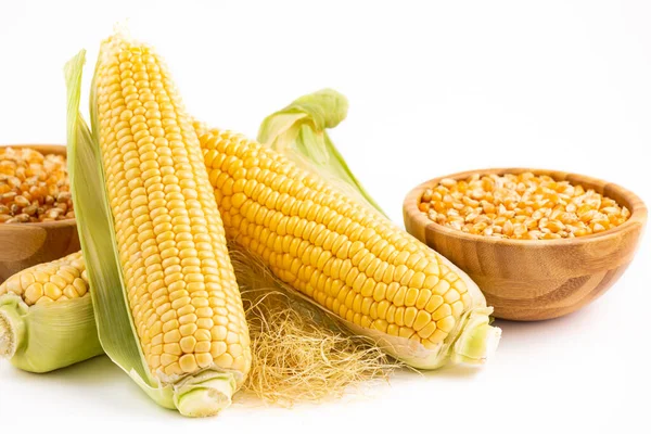 Fresh Corn with leaves and Corn kernels in a wooden bowl isolated on white background.