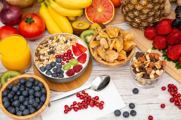 stock image Group Fruits Breakfast mixed vegetables with salad bowl, nuts bowl, strawberry, banana, and pineapple, orange juice,  vitamin c in food  nature for health and diet in the top view on the wood table.