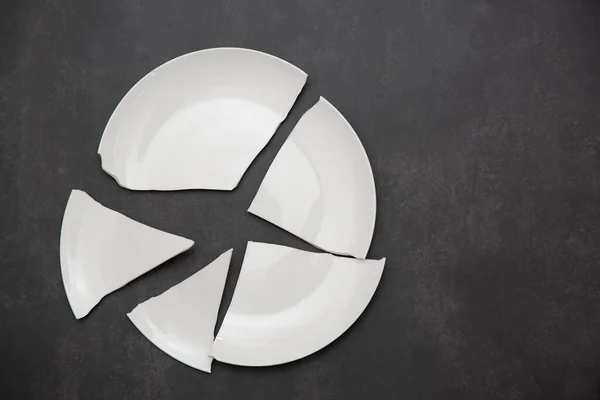 Broken Plate or broken water glass and dishes on black background concept of accidents in the kitchen is dangerous for the body and young children inside the house.