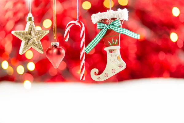 Merry Christmas holiday with star and red hearts , toy socks, Merry Christmas and happy New Year and Family happiness festival on red bokeh background Beautiful decorations