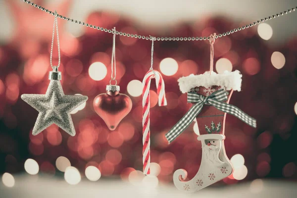 Merry Christmas holiday with star and red hearts , toy socks, Merry Christmas and happy New Year and Family happiness festival on red bokeh background Beautiful decorations