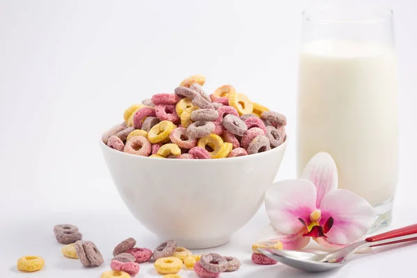 Corn cereal breakfast flake in children cups and milk is a healthy breakfast that is good for your body every day on a white background.