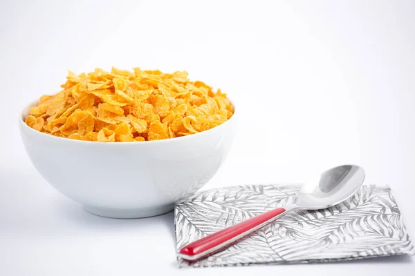 Natural corn flake breakfast cereal in cups and milk is a healthy breakfast that is good for your body every day on a white background.