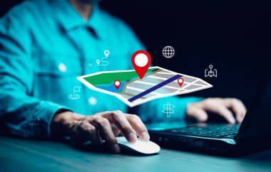 Man using laptop with virtual world and model map with location point , GPS app, icon Travel maps and find places in the online system, all screen graphics are generated,Searching for travel.