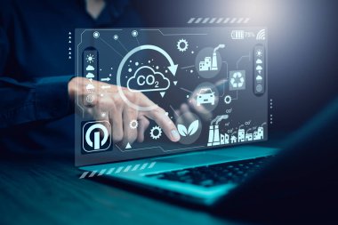 Businessman using laptops and touch recycle symbol with virtual modern reduce CO2 emission concept with icons, global warming emissions carbon footprint climate change to limit global warming, energy