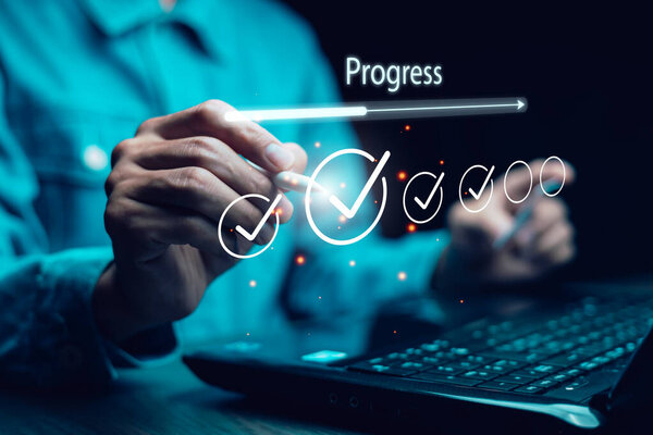 Business progress and goal achievement concept. A person marks completed tasks on a virtual checklist, symbolizing productivity, project management, and success tracking in digital work environments.