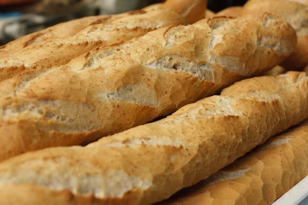 Wholemeal bread sticks fresh from the oven in a bakery — Stock Photo, Image