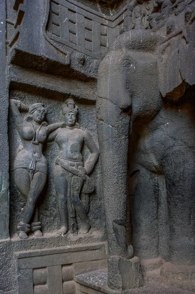 15 May 2009-Couple and life size elephant carved on the gate wall of rock cut Karla cave buddhist site Lonavala. Maharashtra INDIA asia