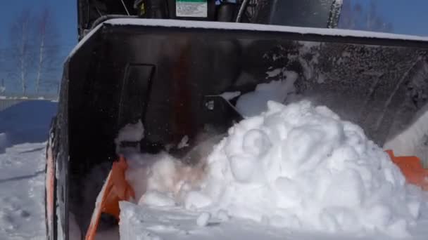 Orange spinning blades of a snow blower. — Stock Video