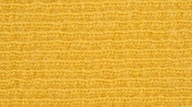 Tekstil arka planı - sarı pamuk kumaş ve forma kabartma yapısı. Makro atış.