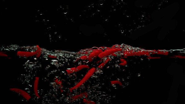 Red chilli and water splash isolated on black background