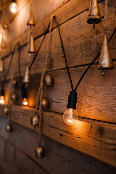 Hanging light bulb over the wooden background. Background wood planks with lamps