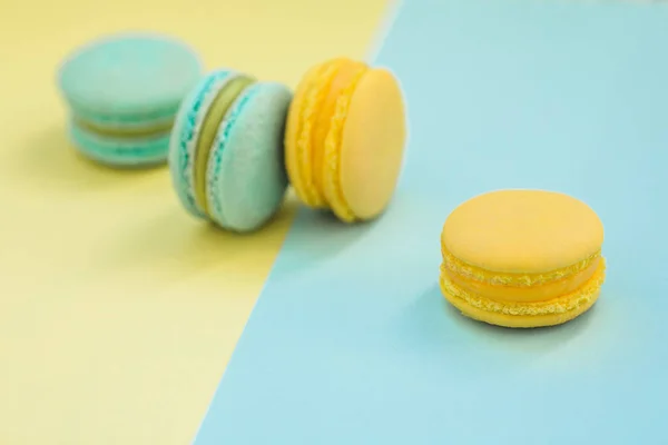 Macarons cake, top view flat lay, handmade pattern on yellow and blue background. Concepts about decoration, food background.