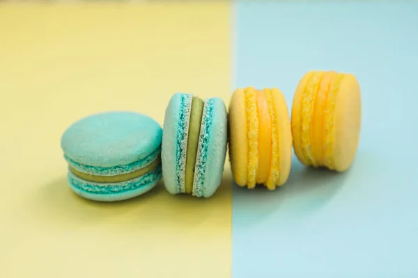 Macarons cake, top view flat lay, handmade pattern on yellow and blue background. Concepts about decoration, food background.
