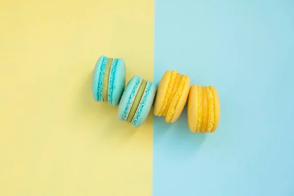 Macarons cake, top view flat lay, handmade pattern on yellow and blue background. Concepts about decoration, food background