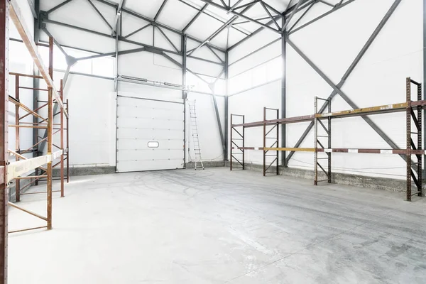 Interior of empty warehouse with empty racks