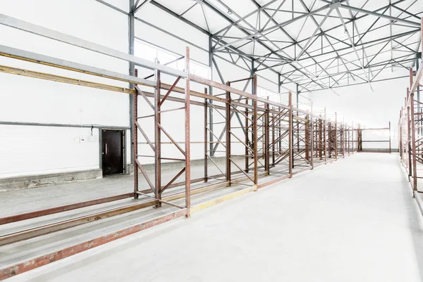 Interior of empty warehouse with empty racks