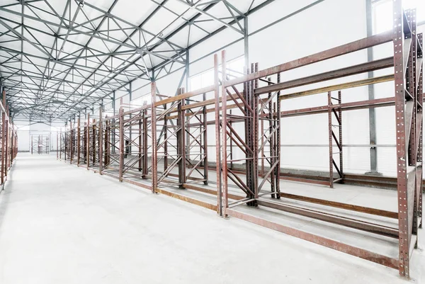 Interior of empty warehouse with empty racks