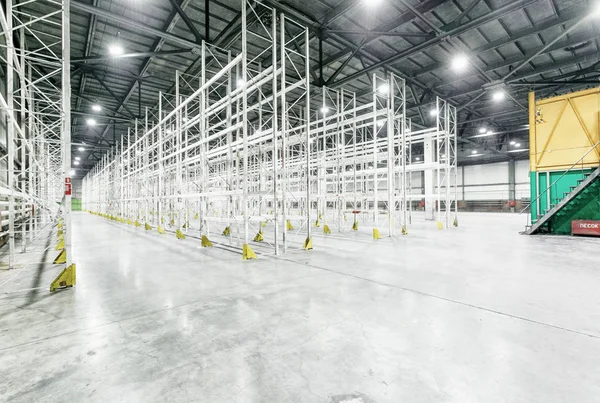 Interior of empty warehouse with empty racks