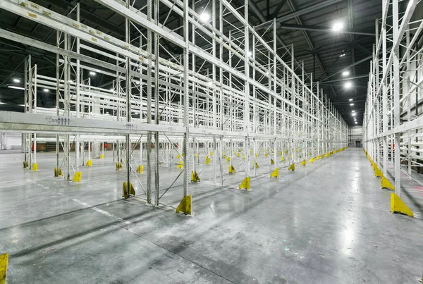 Interior of empty warehouse with empty racks