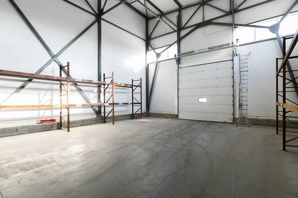 Interior of empty warehouse with empty racks