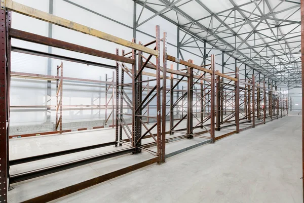 Interior of empty warehouse with empty racks