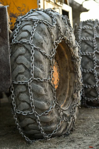 Snow tire chains on big truck wheel — Stock Photo, Image