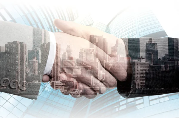 Double exposure of two business people handshake and city. — Stock Photo, Image