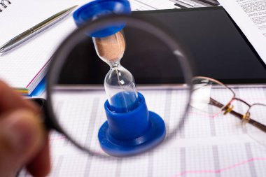 Kum saati. Arka ofiste çalışan iş adamı. Kavram zaman para demektir.