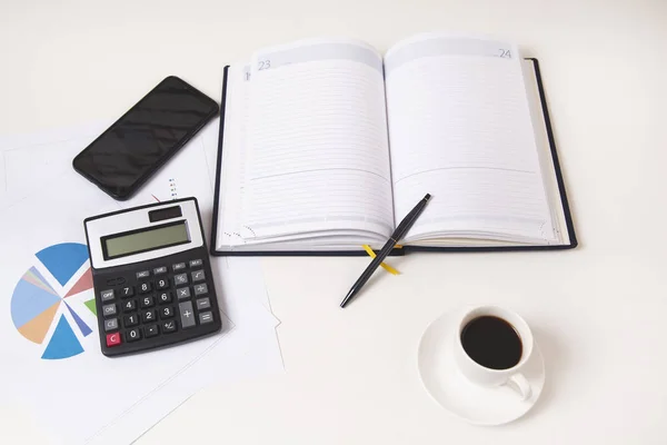 Calculator with notepad and phone on desk — Stock Photo, Image