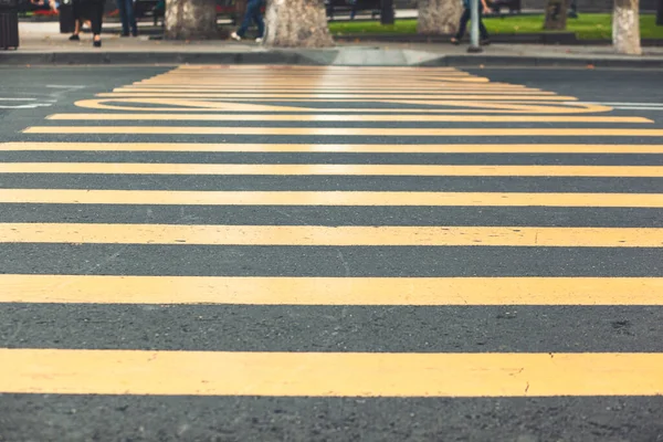 Yellow pedestrian crossing the road in the city