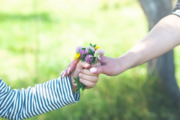 Mother and child to hand over the flower