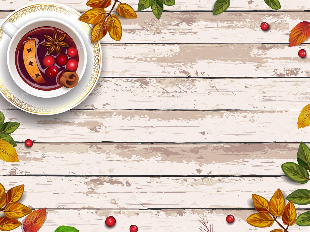 Autumn leaves and mulled wine on wooden background